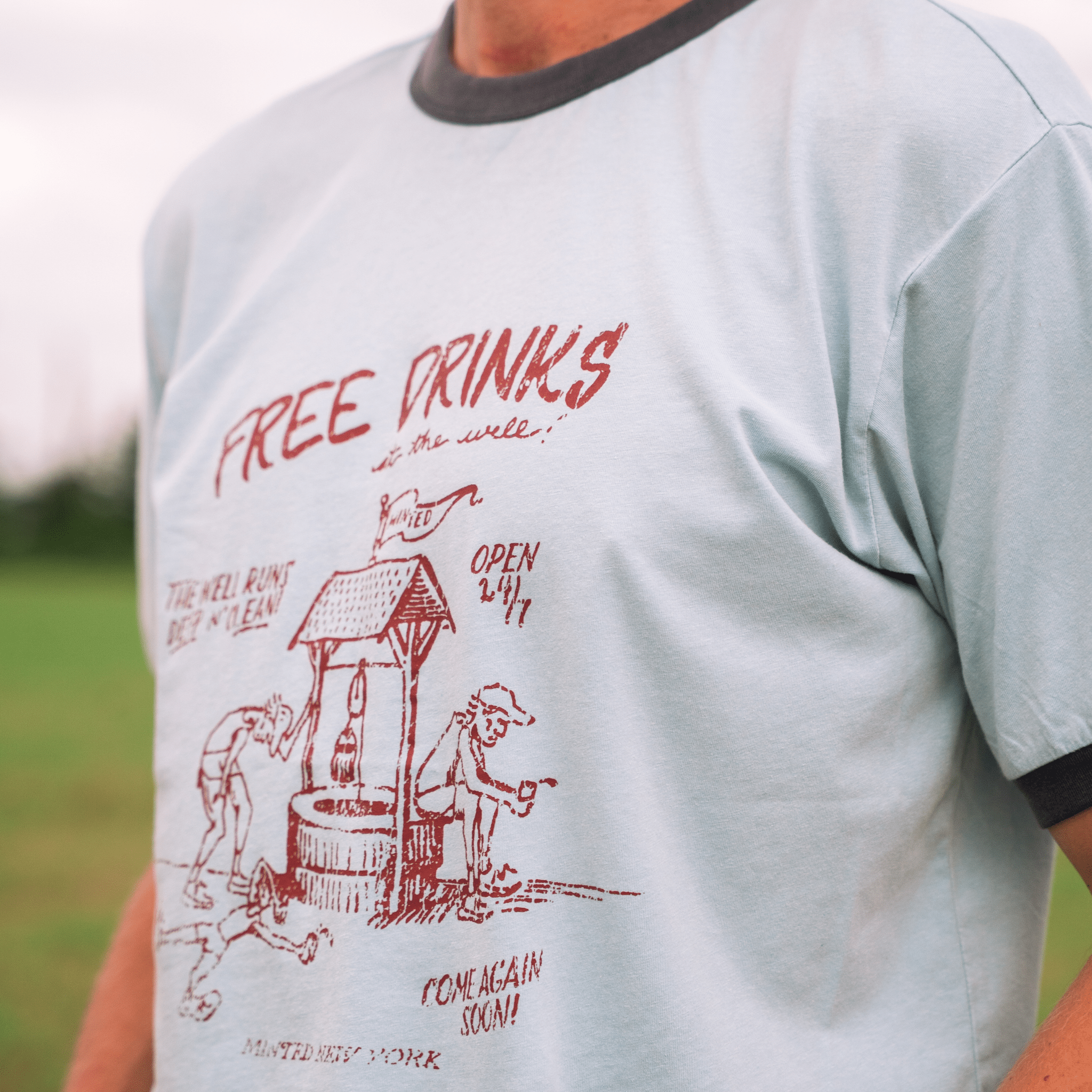 LinoCotton Ringer Tee "Free Drinks at the Well" - Minted New York